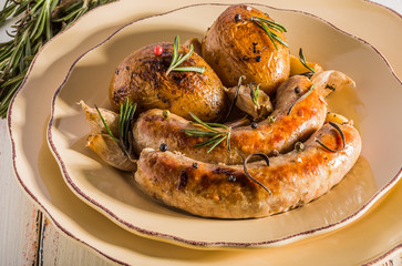 Rustic style potatoes and fried sausages