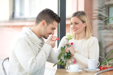 Romantic young man kissing hand of his girlfriend