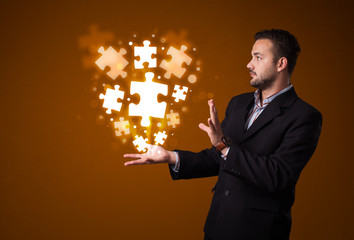 Puzzle pieces in the hand of a businessman
