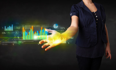 Young business woman touching colorful charts and diagrams