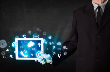 Person holding a tablet with blue technology icons and symbols