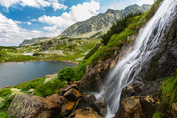 Naklejka na ściany i meble Beautiful waterfalls in the mountains, in summer