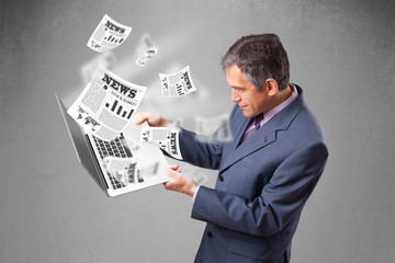 Middle aged businessman holding notebook and reading the explosi