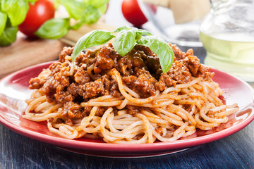 Spaghetti bolognese with cheese and basil