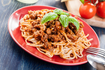 Spaghetti bolognese with cheese and basil