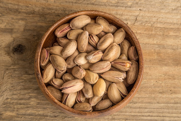 pistachios on wooden surface