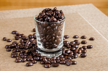 Coffee beans in glass shot with warm tone