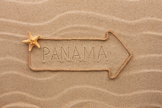 Arrow made of rope and sea shells with the word Panama on the sa
