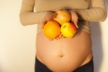 Pregnant woman holding a fruits