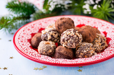 Assorted dark chocolate truffles on red plate