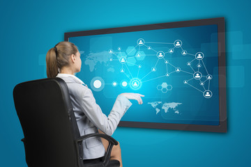 Businesswoman using touch screen interface
