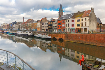 River Leie, colored houses and Belfry tower in Ghent, Belgium