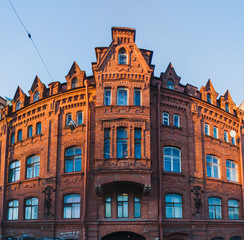 Fototapeta premium Panoramic view of an old red brick building near New Holland Isl