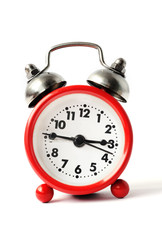 red alarm clock with white dial