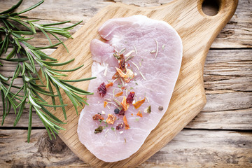 Pork chop, meat slices  on a wood background.