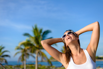 Joyful young woman on tropical caribbean travel