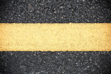 Fototapeta premium Yellow line on road texture