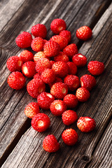 Wild strawberry on a wooden background