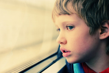 Cute Boy looking through the window