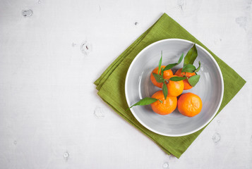 Tangerines on white wooden background. Free space for text