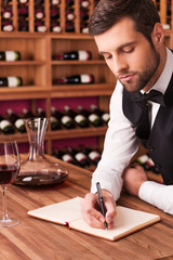 Making notes about wine.