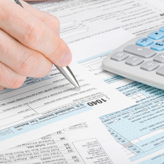 Man filling out 1040 tax form