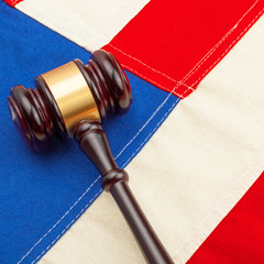 Wooden judge gavel over US flag