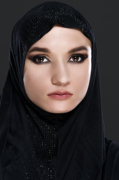 Beautiful muslim arabic woman on grey background