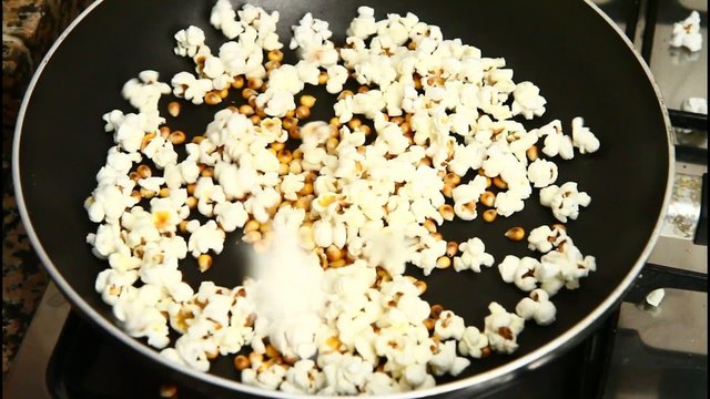 homemade popcorn cooking in slow motion in a pan