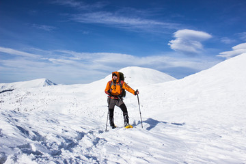 Fototapeta na wymiar Winter hiking in the mountains on snowshoes .