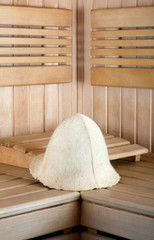 Obraz na płótnie Canvas Traditional wooden sauna for relaxation with felt hat