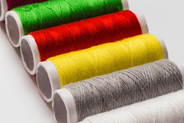 close up colorful thread bobbin