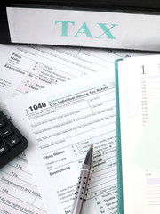 Fototapeta na wymiar U.S. Individual tax form 1040 with calculator and pen.