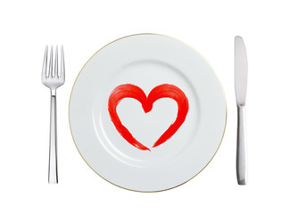 white plate with paint red heart symbol, spoon and fork isolated