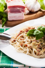 Spaghetti carbonara with bacon and basil