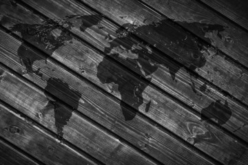 World map on the background of black wood boards.