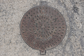 Manhole with metal cover asphalt surface