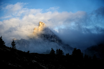 Mount Sass de Stria at sunrise in the clouds, Dolomites, Italy