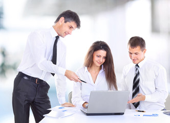 smiling female boss talking to business team