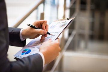 hands pointing at business document