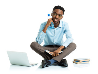 Happy african american college student sitting on white with lap