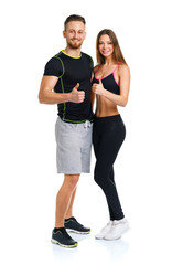 Sport man and woman after fitness exercise with a finger up on t