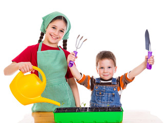 Two kids planting the seedling