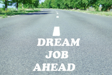 Text Dream Job Ahead marking on road surface