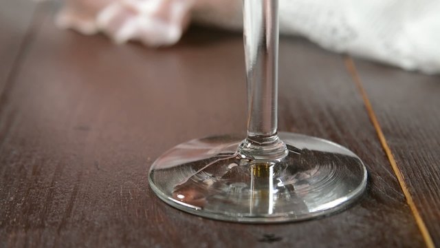 A drip of Burgundy wine running down a goblet