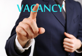 Businessman hand pushing Vacancy sign