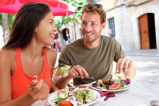 Restaurant tourists couple eating at outdoor cafe - Powered by Adobe