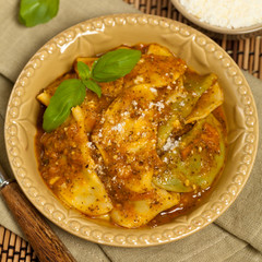 Ravioli with tomato sauce and parmesan cheese. Selective focus.