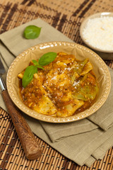 Ravioli with tomato sauce and parmesan cheese. Selective focus.