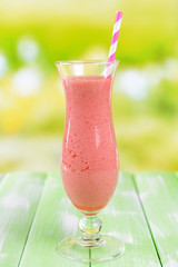 Delicious berry cocktail on table on bright background